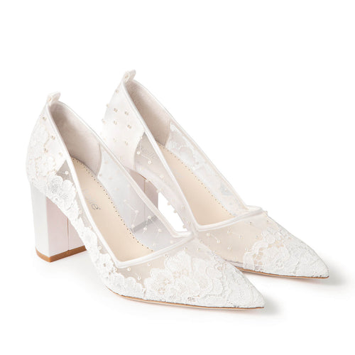 Ivory lace pointed-toe pumps with ankle strap, side view
