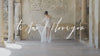 woman in wedding dress walking around building with pillars and tile floor in wedding shoes